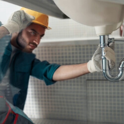 A Man Repairing Sink